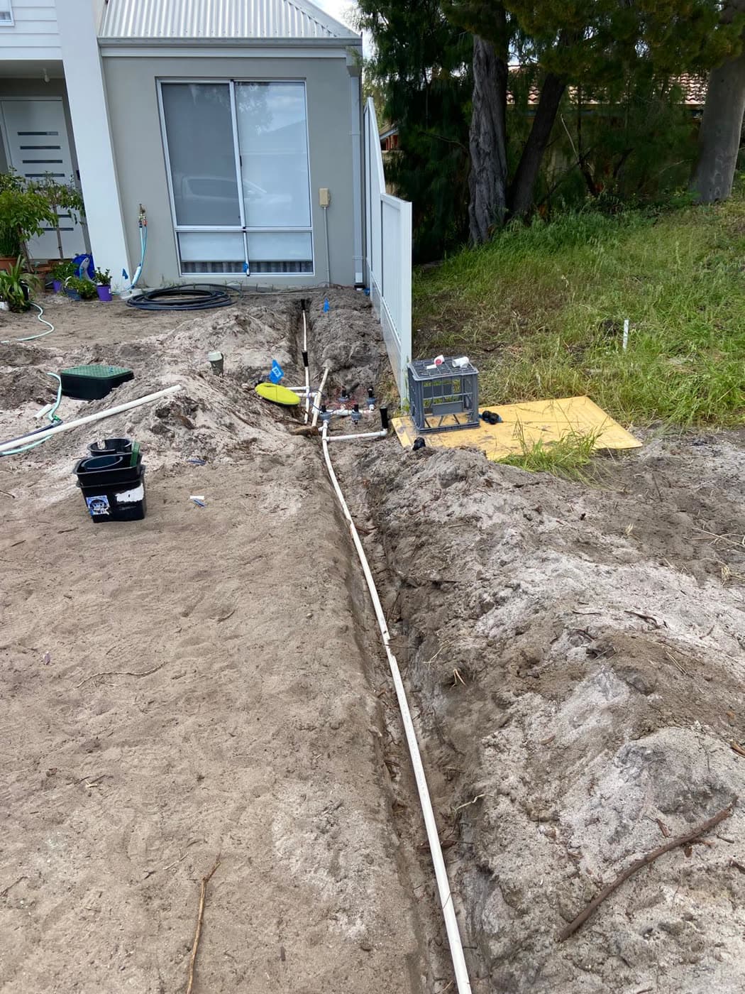 Trench dug and the new reticulation mainline laid along the house.
